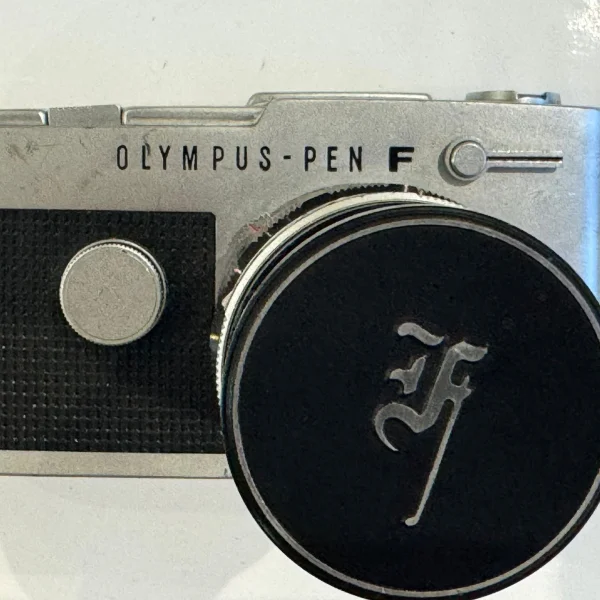Olympus Pen F half-frame SLR with lens cap